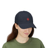 Person wearing a navy blue cap with a red logo on a white background