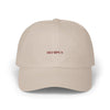 Beige cap with 'OLYMPUS' logo on a white background